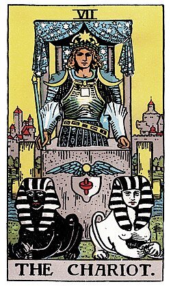 The Chariot card from the Rider-Smith-Waite deck where a chariot is pulled by 2 different sphinxes of black and white while the rider is clad in armor before